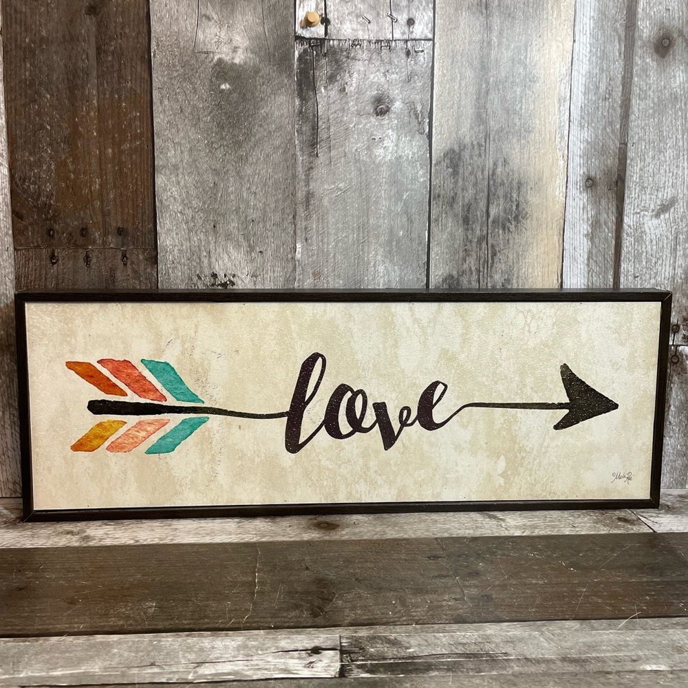 “Love” written in an Arrow Hanging Wall Sign